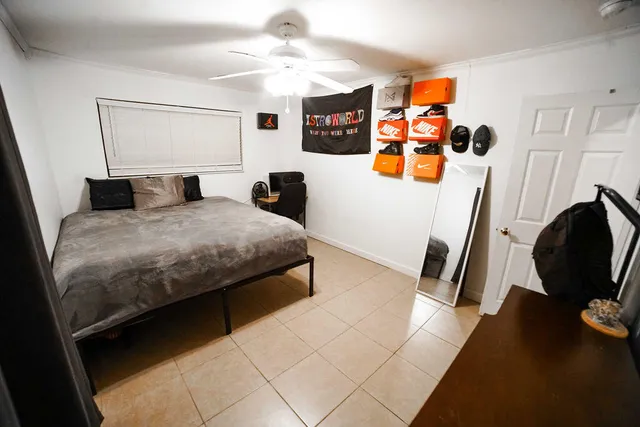 a bedroom with a bed a couch and dresser