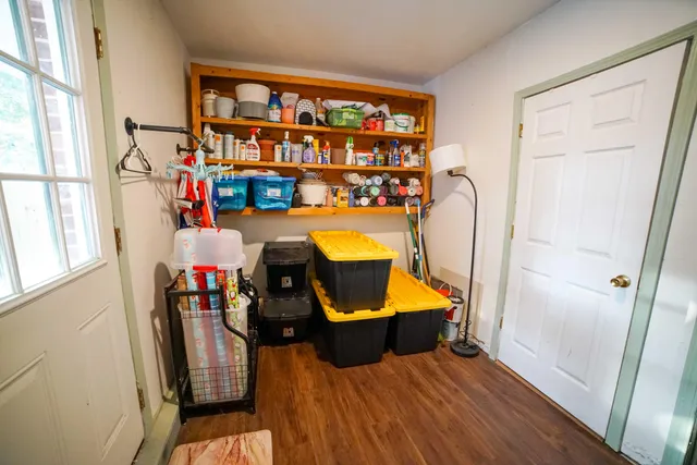 a view of living room with furniture and wooden floor