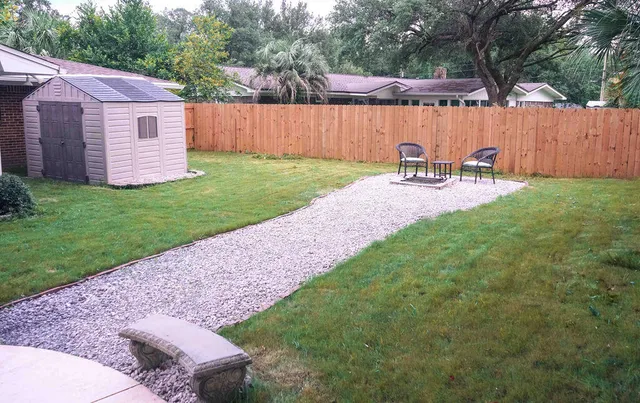 a view of a backyard with table and chairs and a big yard