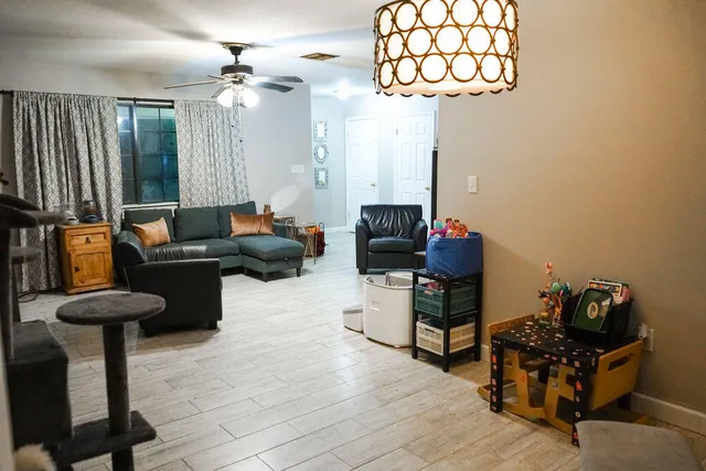a living room with furniture and a chandelier