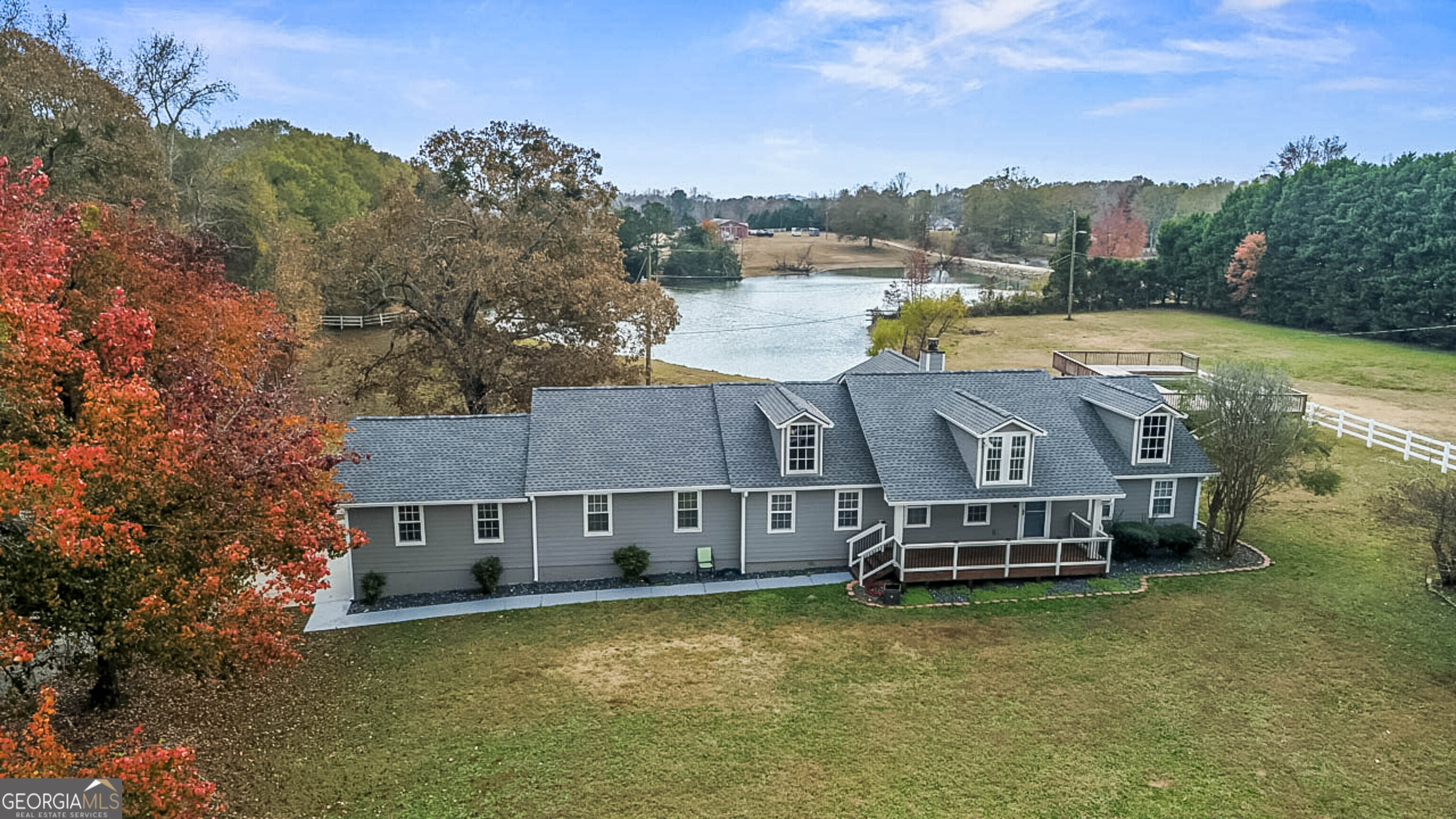 a aerial view of a house with a garden and lake view