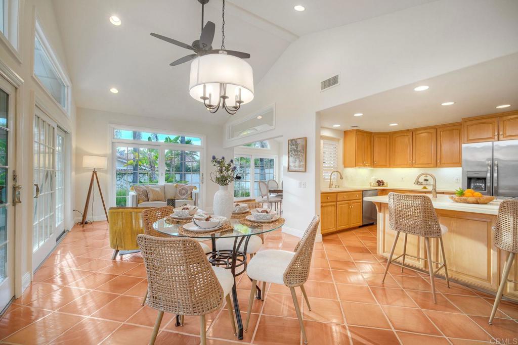 13253 Edina Way Poway, CA 92064 - Photo 19 of 55 Eat in kitchen, sunroom beyond the table, kitchen, terracotta flooring, vaulted ceiling