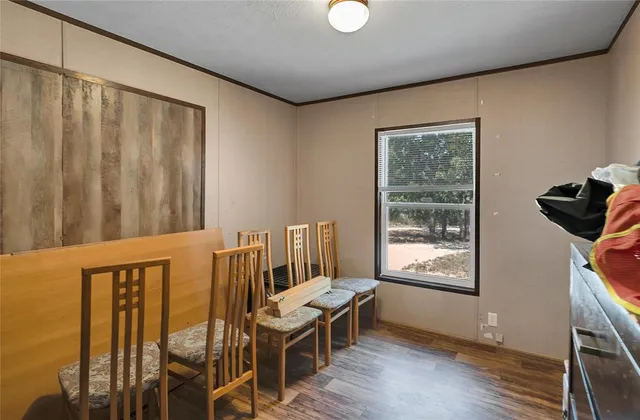 a view of a room with furniture and wooden floor