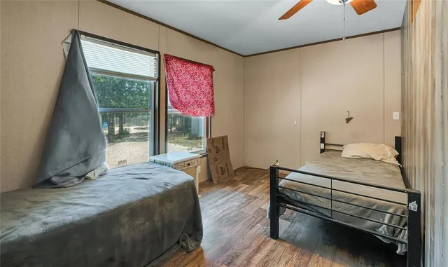 a bedroom with a bed and large window