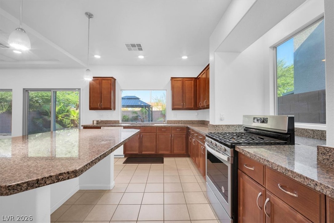 8046 Noble Ridge Street Las Vegas, NV 89139 - Photo 10 of 34 A well-appointed kitchen offers rich cabinetry, ample counter space, and a generous island perfect for culinary pursuits.