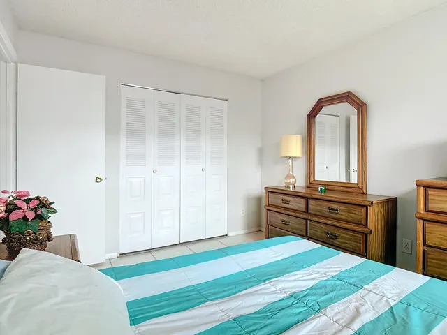 a bedroom with a bed and a dresser