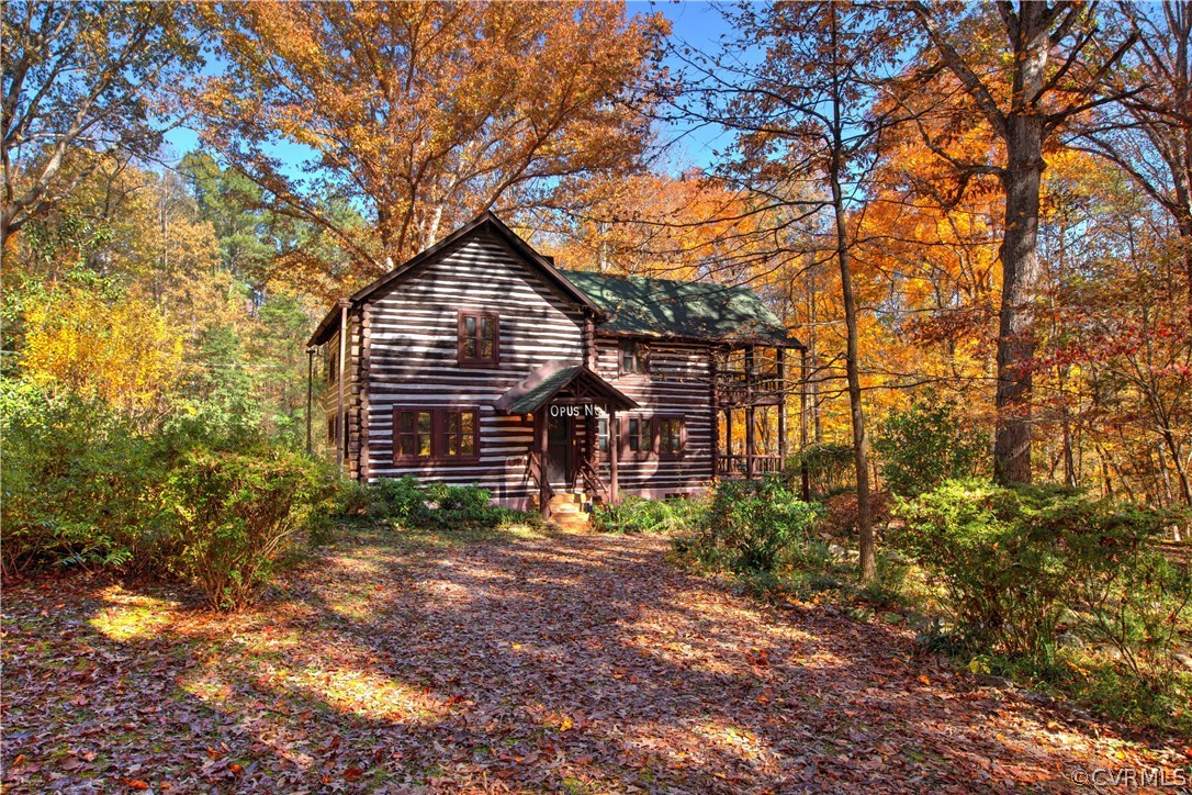 a view of a house with a tree in the yard