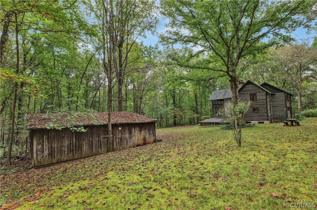 1444 Genito Road Manakin-Sabot, VA 23103 - Photo 36 of 47 a backyard of a house with wooden floor and tree