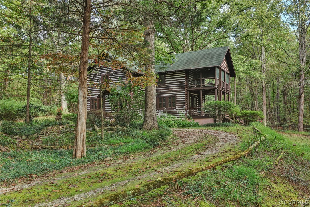 1444 Genito Road Manakin-Sabot, VA 23103 - Photo 44 of 47 a backyard of a house with plants and large trees