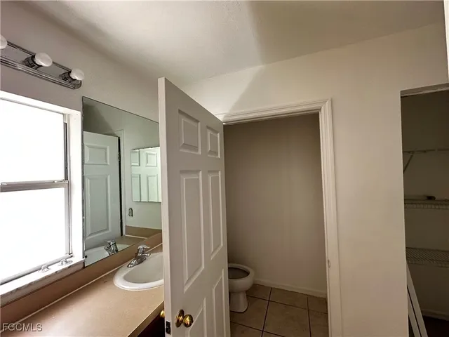 a bathroom with a sink toilet a mirror and shower