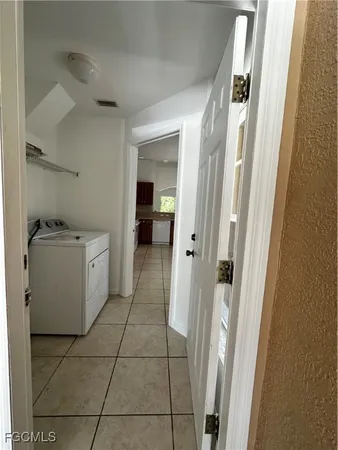 a utility room with cabinets washer and dryer