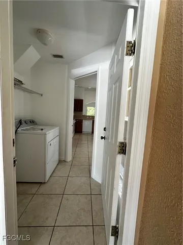 a utility room with cabinets washer and dryer