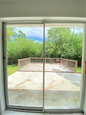 a view of backyard with seating and trees