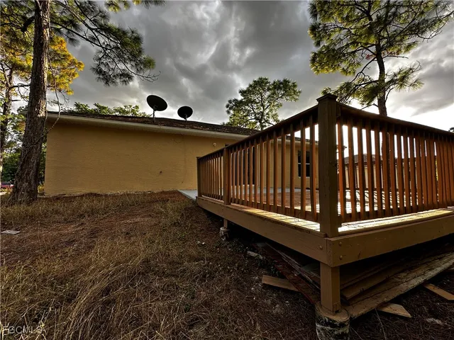 a view of a backyard with a deck and wooden floor