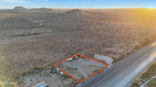a view of a dry yard with mountain view