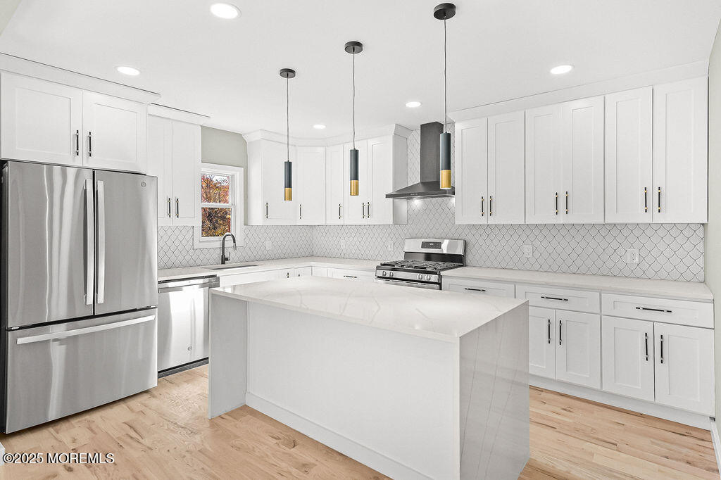 940 Grove Avenue Old Bridge, NJ 08879 - Photo 13 of 48 a kitchen with stainless steel appliances granite countertop a refrigerator a sink dishwasher a stove and white cabinets with wooden floor