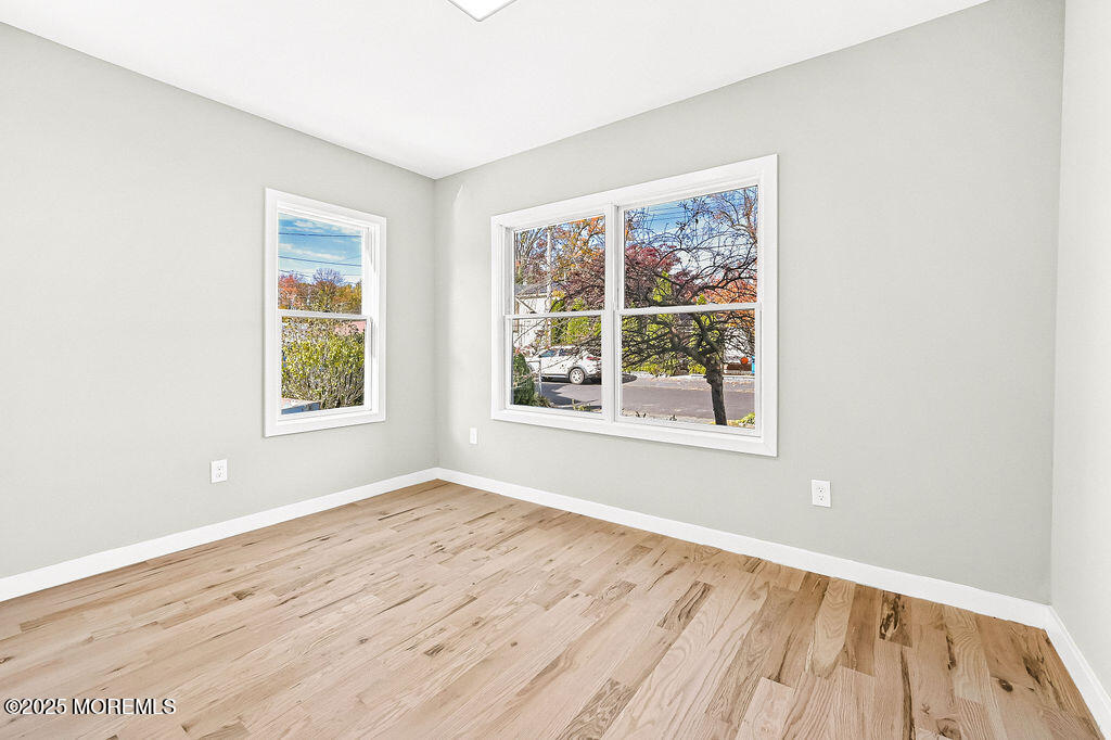 940 Grove Avenue Old Bridge, NJ 08879 - Photo 17 of 48 an empty room with wooden floor and windows