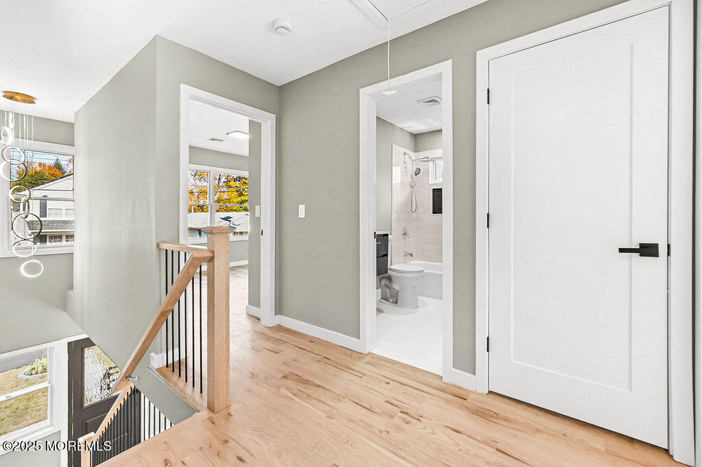 940 Grove Avenue Old Bridge, NJ 08879 - Photo 20 of 48 a view of a hallway with wooden floor and stairs