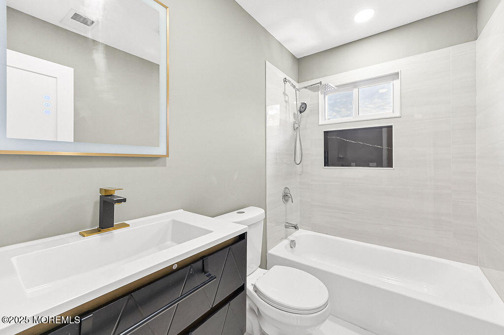 940 Grove Avenue Old Bridge, NJ 08879 - Photo 27 of 48 a bathroom with a sink a toilet and bathtub