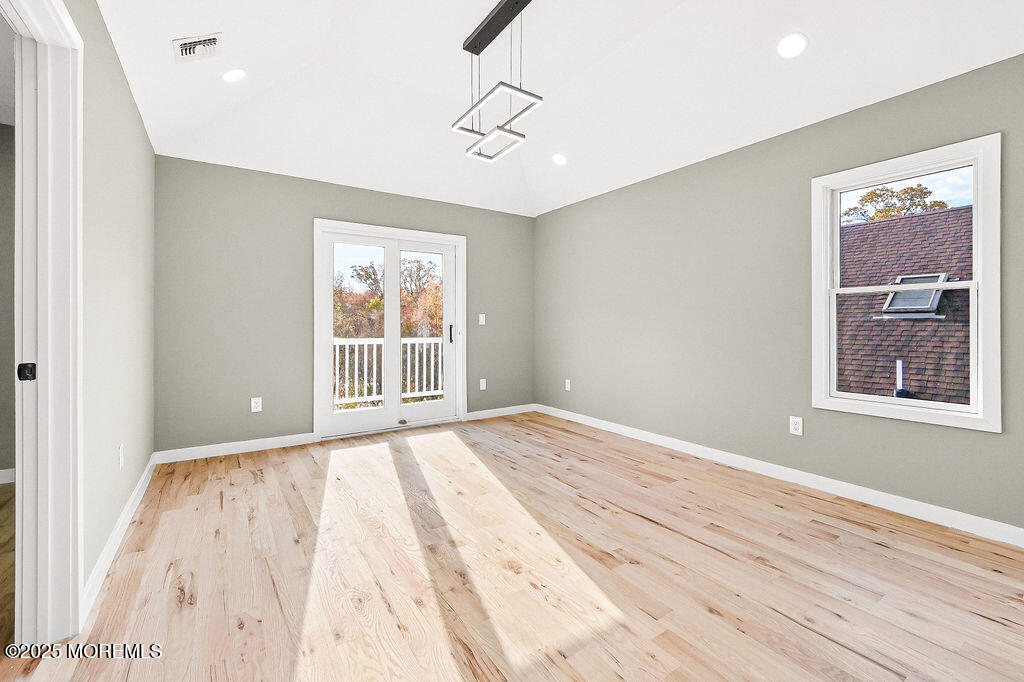 940 Grove Avenue Old Bridge, NJ 08879 - Photo 29 of 48 a view of an empty room with wooden floor and a window