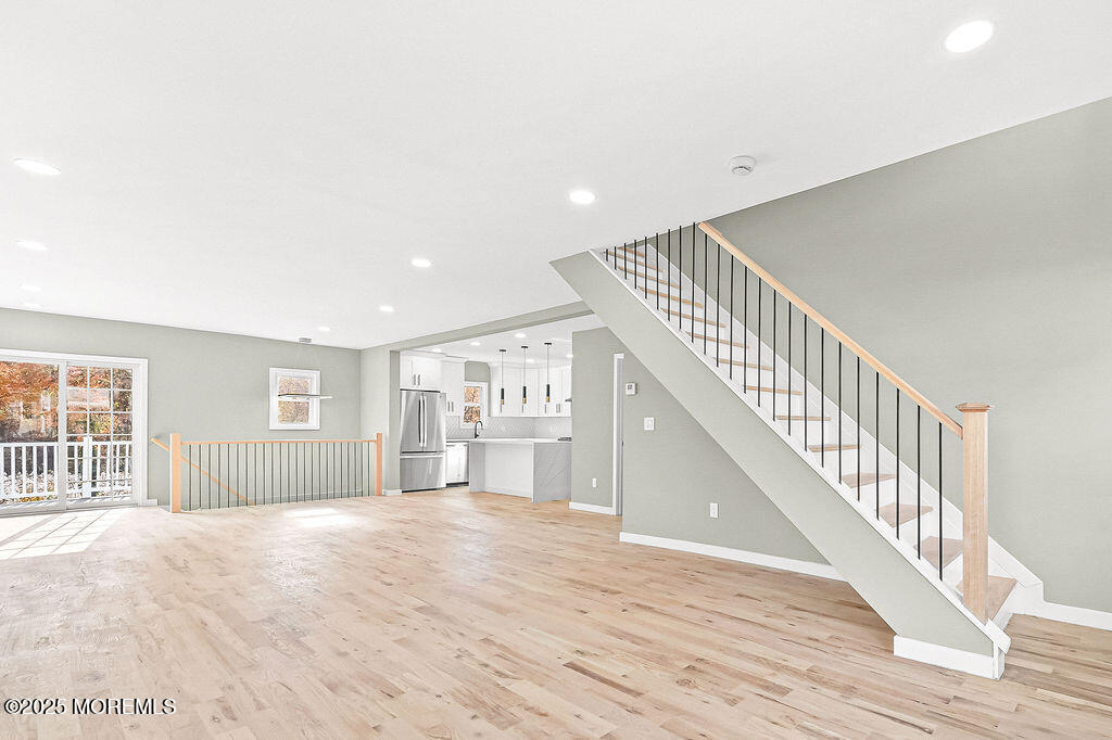 940 Grove Avenue Old Bridge, NJ 08879 - Photo 7 of 48 a view of a livingroom with wooden floor and staircase