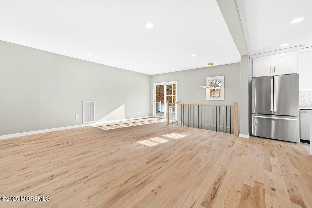 940 Grove Avenue Old Bridge, NJ 08879 - Photo 10 of 48 a view of a livingroom with a kitchen space and wooden floor