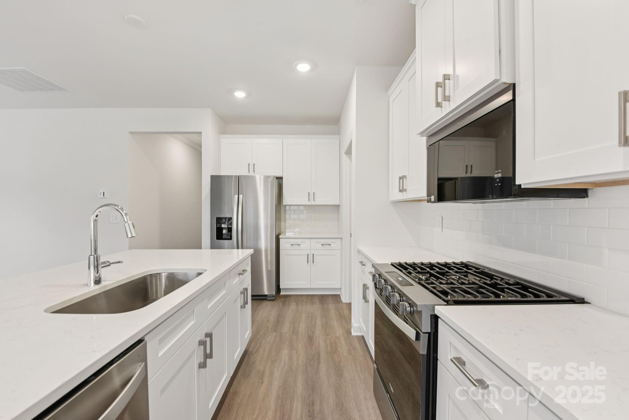 712 Palmer Pendleton Way York, SC 29745 - Photo 11 of 36 a kitchen with stainless steel appliances granite countertop a sink stove and refrigerator