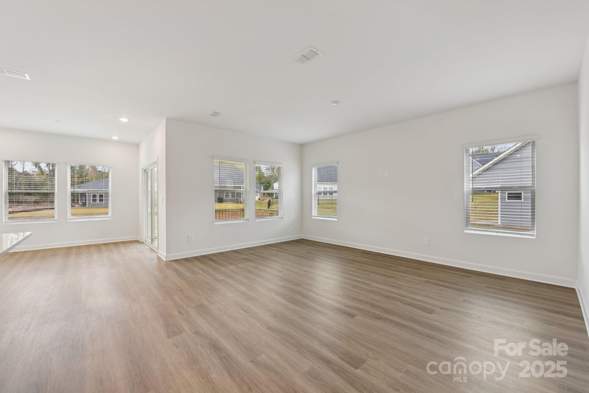 712 Palmer Pendleton Way York, SC 29745 - Photo 2 of 36 a view of an empty room with a window and wooden floor