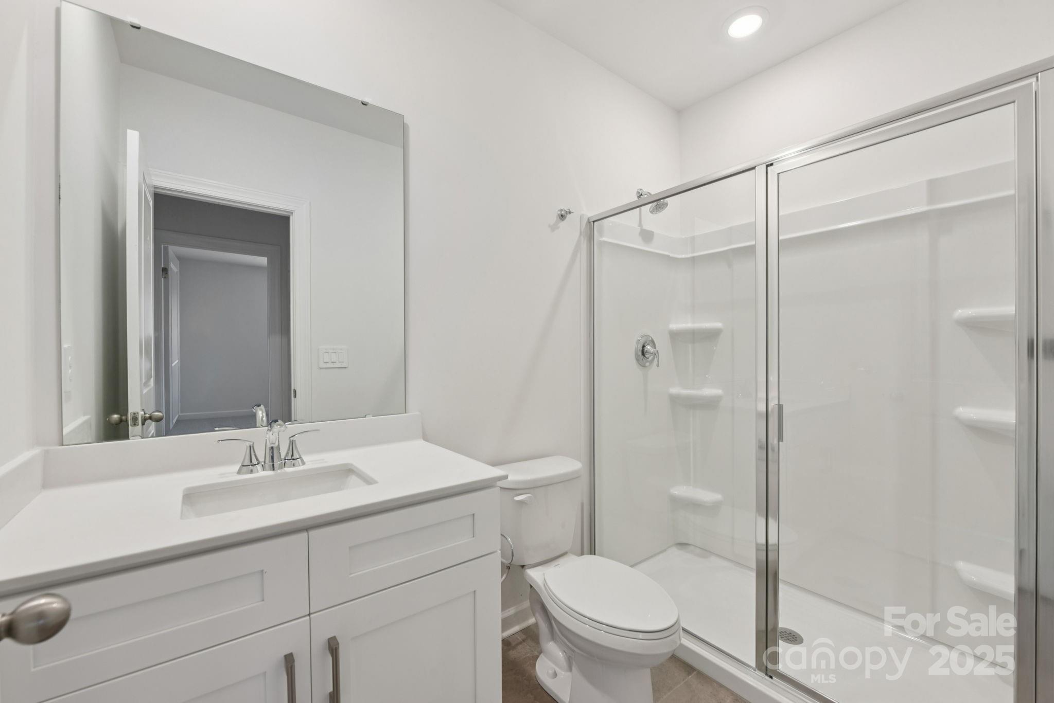 712 Palmer Pendleton Way York, SC 29745 - Photo 26 of 36 a bathroom with a shower sink mirror vanity and toilet