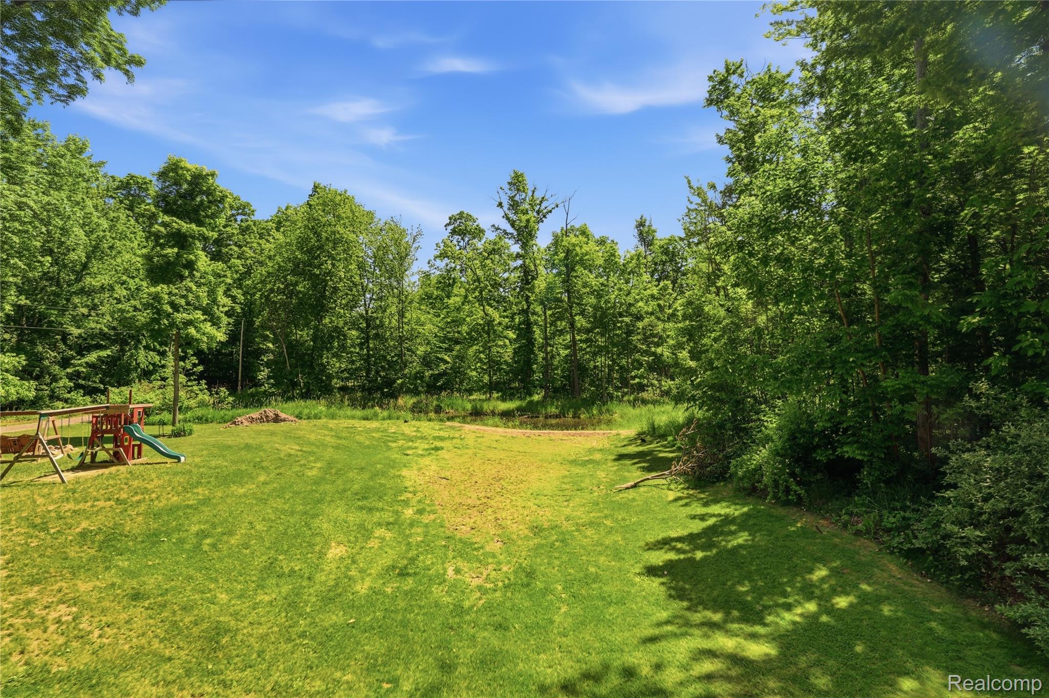 14830 Sheridan Road Byron, MI 48418 - Photo 62 of 74 Expansive grassy yard surrounded by mature trees