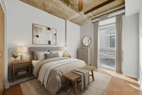 a bedroom with a bed and a lamp on table