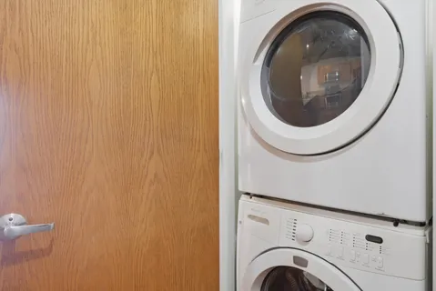a close view of a utility room with dryer and washer
