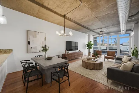 a living room with furniture kitchen view and a chandelier