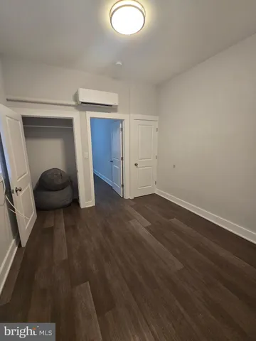 a view of a livingroom with wooden floor and closet