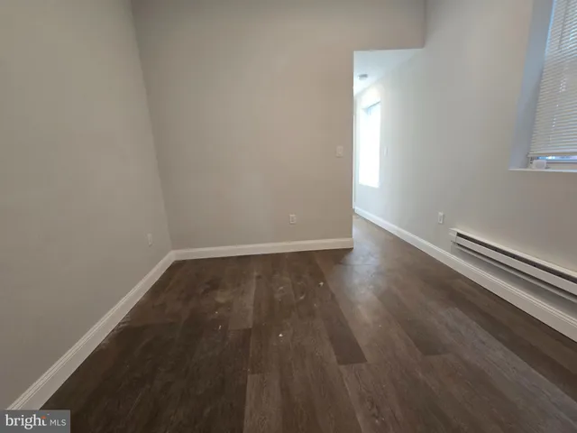 a view of wooden floor and windows in a room