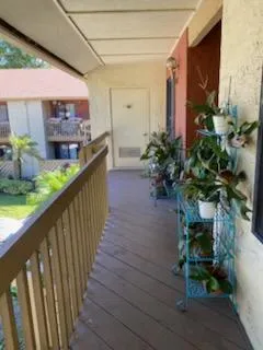 a porch with seating space and hardwood floor