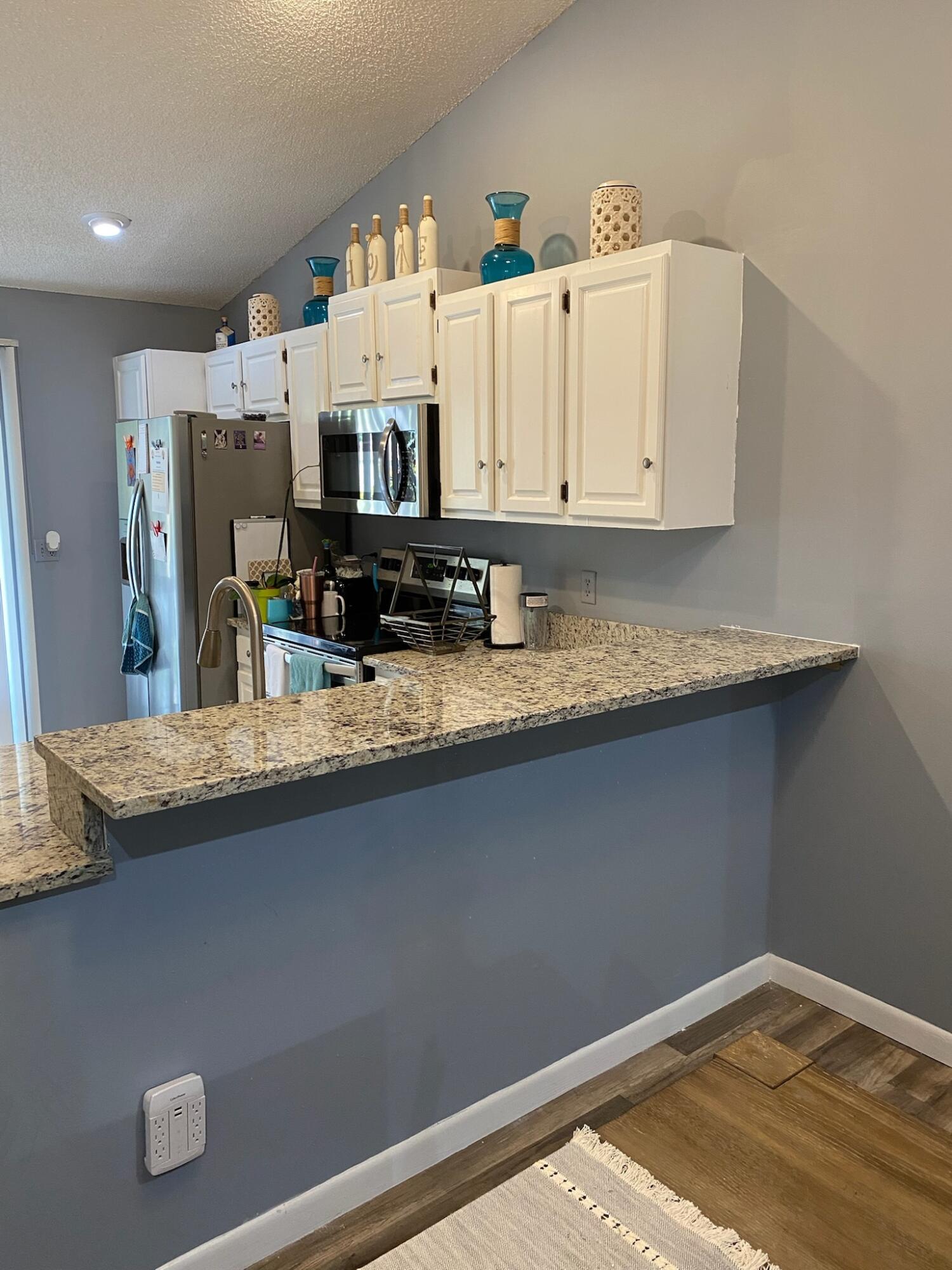 12989 Odessa Trail, Unit 3 Wellington, FL 33414 - Photo 13 of 32 a view of kitchen with stainless steel appliances granite countertop cabinets and sink
