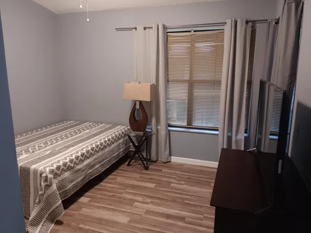 a bedroom with a bed and a chandelier