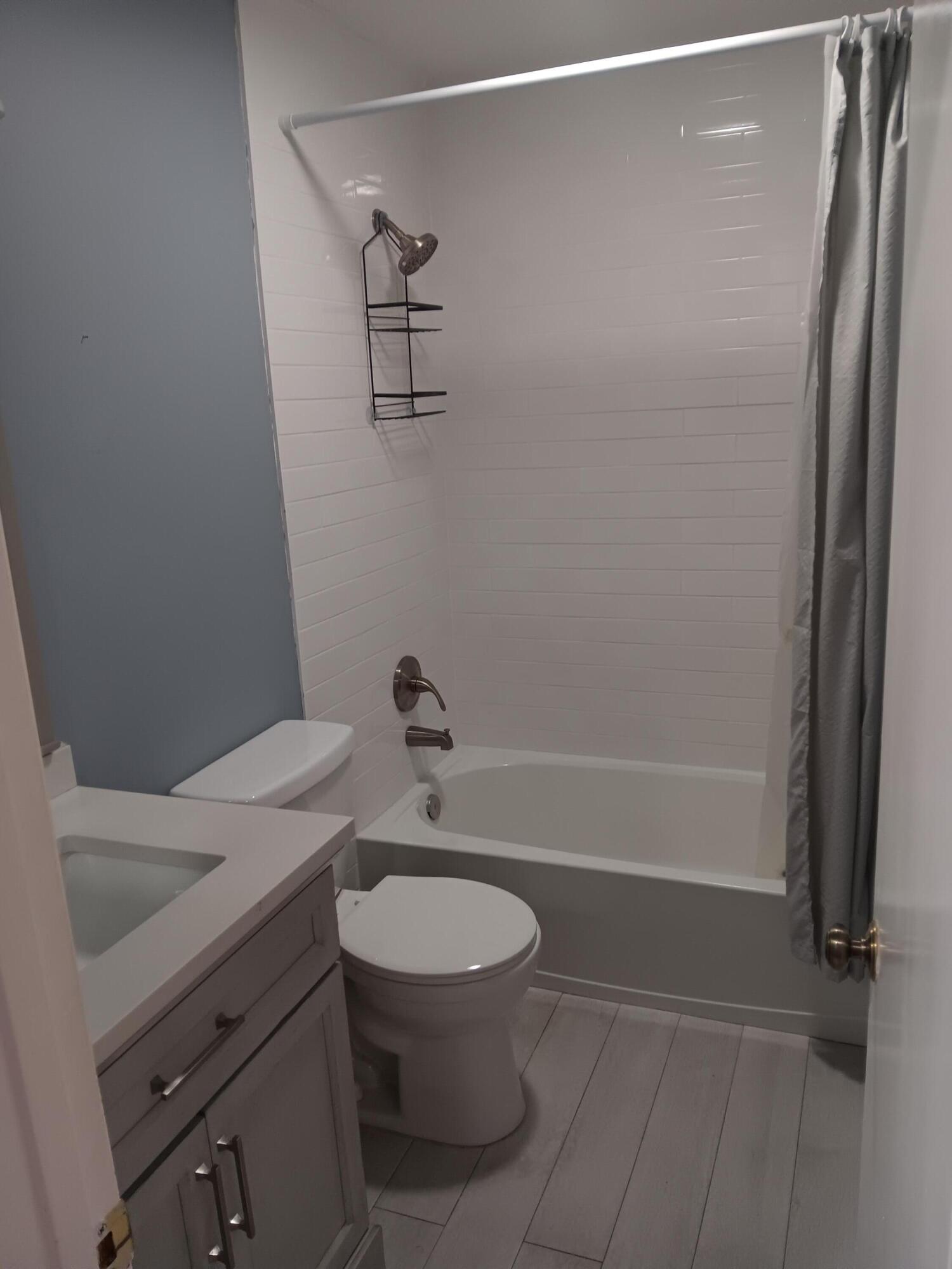 12989 Odessa Trail, Unit 3 Wellington, FL 33414 - Photo 22 of 32 a bathroom with a sink a toilet and shower