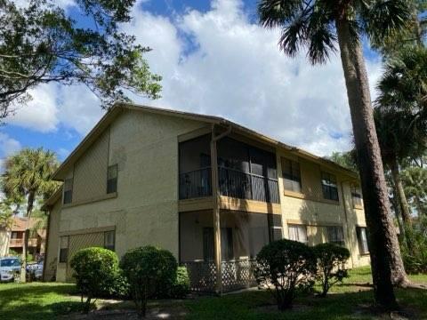 12989 Odessa Trail, Unit 3 Wellington, FL 33414 - Photo 28 of 32 a front view of a house with a garden