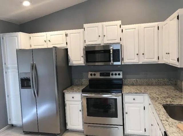 a stove top oven sitting inside of a kitchen