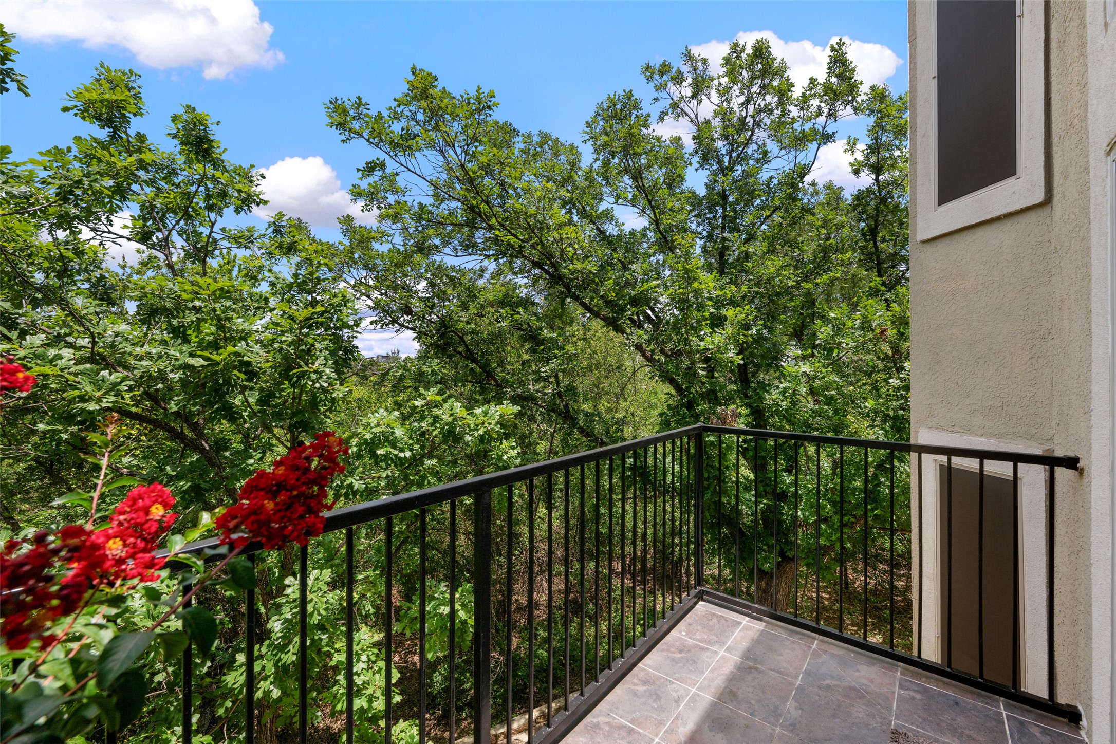 11203 Ranch Road 2222, Unit 1407 Austin, TX 78732 - Photo 19 of 40 The surrounding tree tops make the balcony feel like a treehouse retreat.
