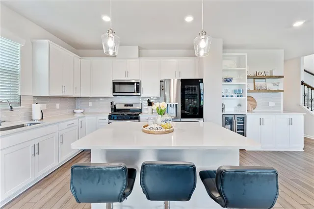 a view of a dining room with furniture large windows and wooden floor