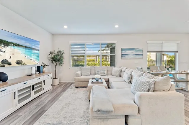 a living room with furniture and kitchen view