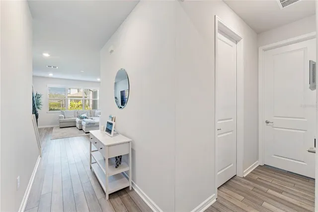 a living room with furniture and view of kitchen