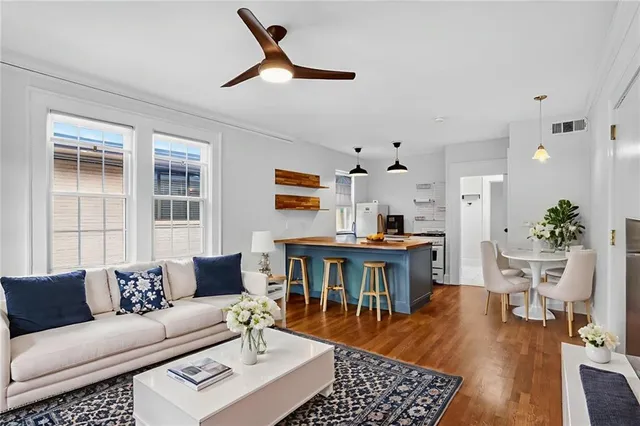 a living room with furniture a window and a dining table