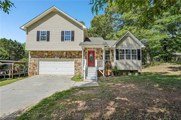 a front view of a house with a yard and garage