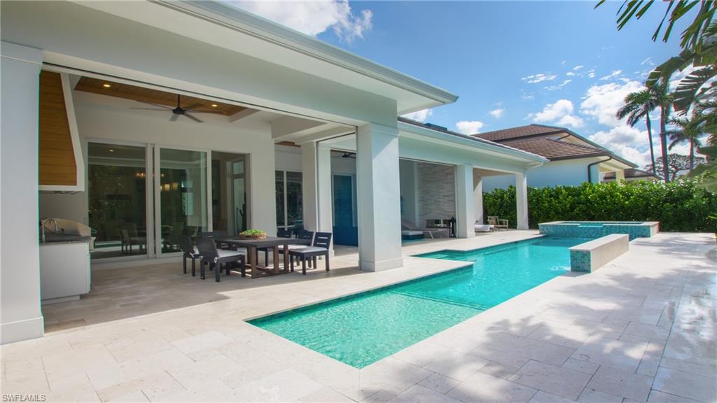 700 Wedge Drive Naples, FL 34103 - Photo 1 of 19 a view of a house with garden and a patio