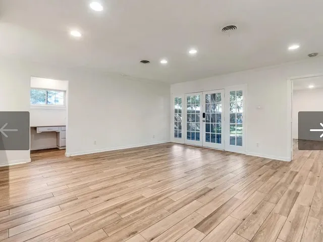 a kitchen with granite countertop a refrigerator stove top oven and sink