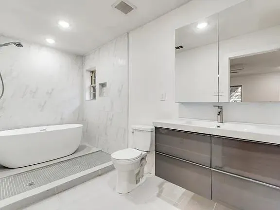 a view of empty room with wooden floor and fireplace